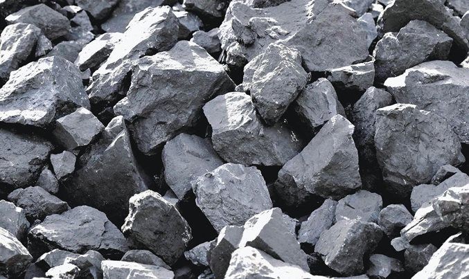 Close-up of a pile of black, jagged coal rocks.